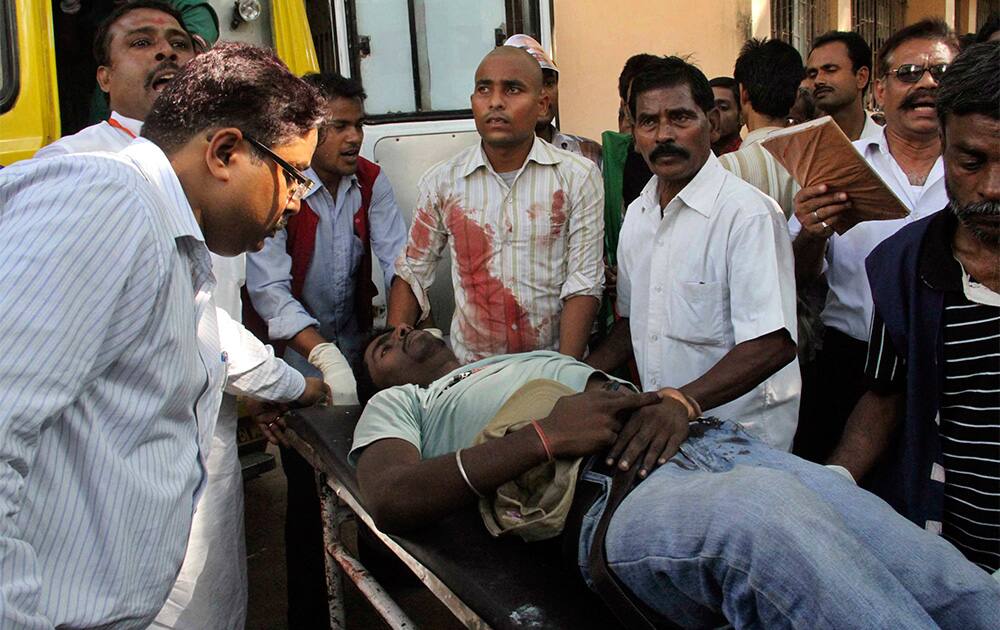 A man injured in bomb blasts is taken in a stretcher for treatment at the government medical college hospital in Patna, India.