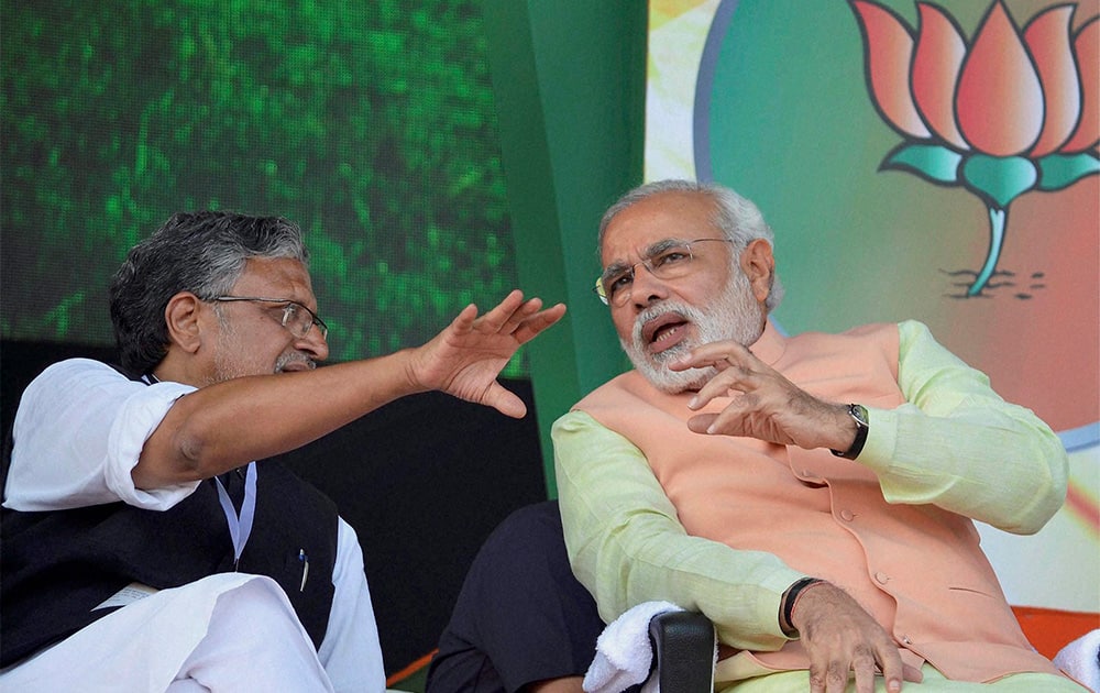 Gujarat Chief Minister and BJP`s Prime Ministerial candidate Narendra Modi with party leader Sushil Kumar Modi at the Hunkar rally in Patna.