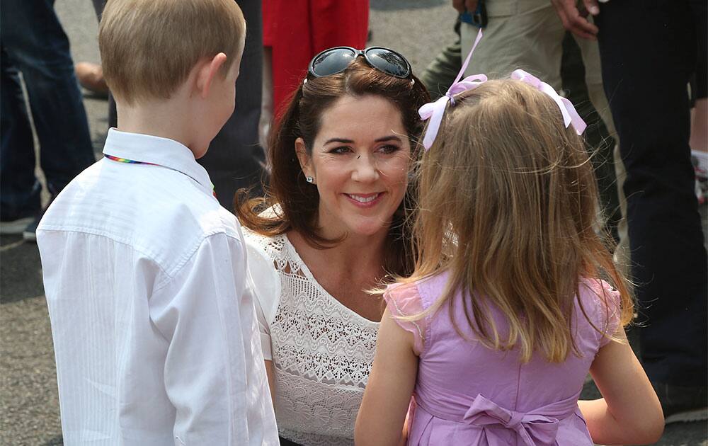 Denmark`s Crown Princess Mary speaks to young children on the street during a tour of bush fire devastation in Winmalee 85 kilometers (53 miles) west of Sydney in Australia.