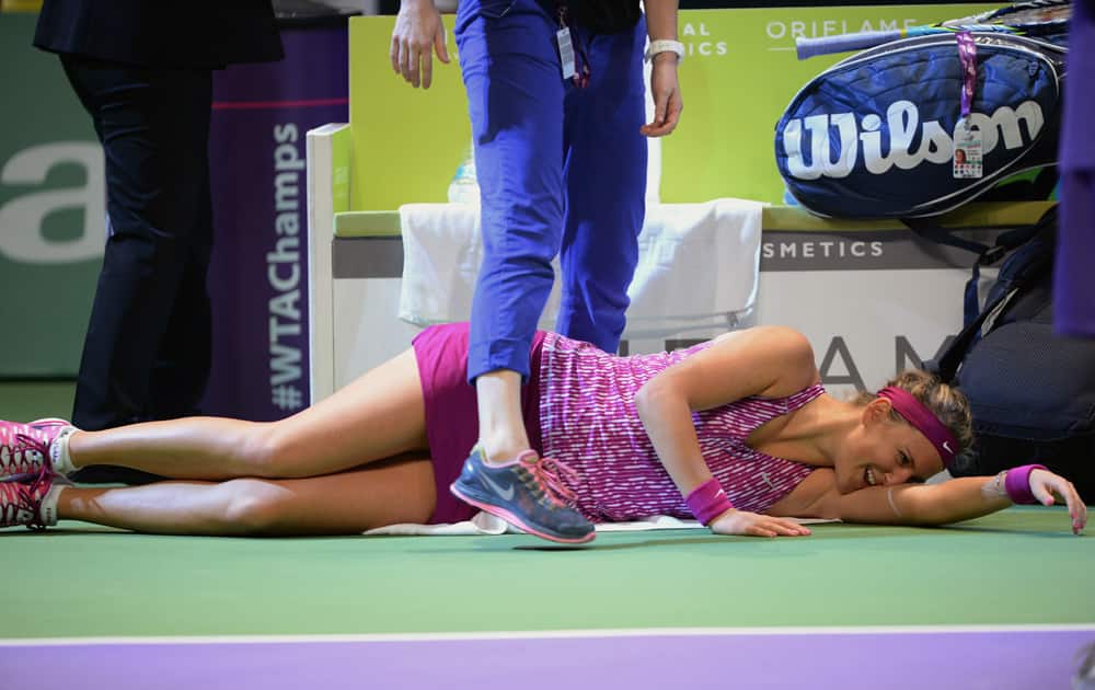 Victoria Azarenka of Belarus lies on the ground after she was injured during her tennis match with Li Na of China at the WTA Championship in Istanbul, Turkey.