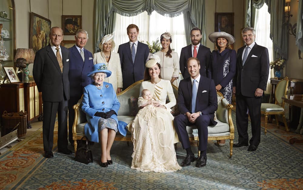 Kate Duchess of Cambridge holds her son Prince George seated next to Queen Elizabeth II and Prince William, back row from left, Prince Philip, Prince Charles, and the Duchess of Cornwall, Prince Harry, Pippa Middleton, James Middleton, Carole Middleton and Michael Middleton.