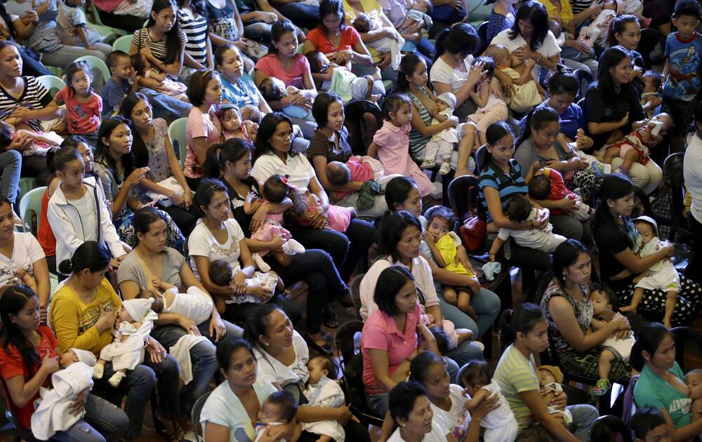 Filipino mothers breastfeed their babies during a mass breastfeeding program organized by the non-government organization