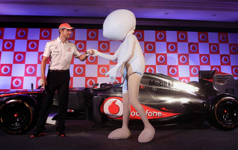 Vodafone McLaren Mercedes racing star Jenson Button with Vodafone ZooZoo during the unveiling of their car for the forthcoming Indian Grand Prix, in New Delhi.