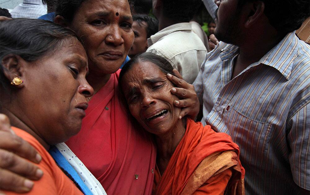 Indians mourn near bodies of victims of a wall collapse after heavy rainfall in Hyderabad. Three members of a family were killed and two injured when a wall collapsed on them while they were asleep, according to a news report.