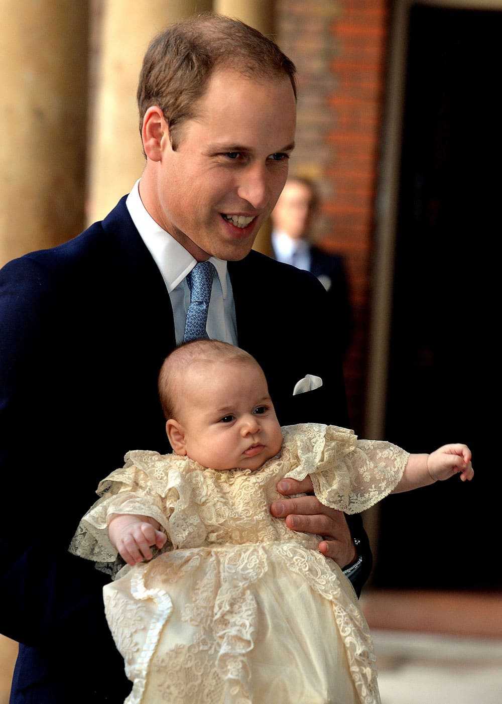 Britain`s Prince William, holds his son Prince George as they arrive at Chapel Royal in St James`s Palace in London, for the christening of the three month-old Prince.