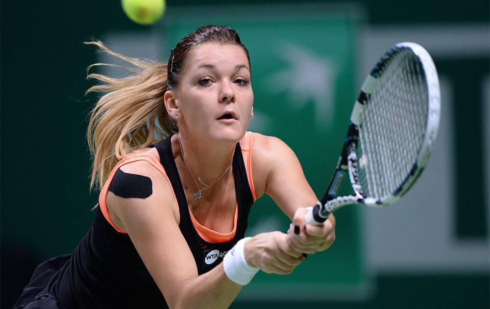 Agnieszka Radwanska of Poland returns a shot to Serena Williams of US during their tennis match at the WTA championship in Istanbul, Turkey.