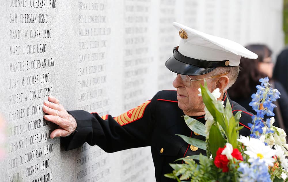 Retired Marine Sergeant Maj. Charles L. Cook, discovers the name of his deceased son, Marine Sgt. Charles D. Cook, on the wall of the Beirut Memorial, at Memorial Gardens, in Jacksonville, N.C.