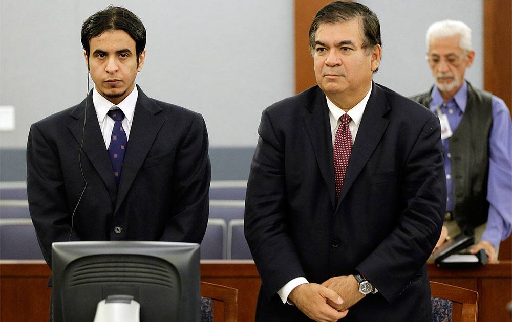 Mazen Alotaibi, left, stands with his attorney Don Chairez as the jury enters the courtroom for the reading of his verdict, at Clark County District Court in Las Vegas.