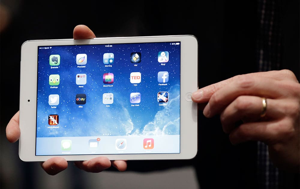 An Apple employee demonstrates the new iPad Mini in San Francisco. Apple unveiled a new, thinner, lighter tablet called the