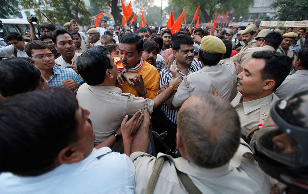 Activists of the right wing Vishwa Hindu Parishad (VHP) tussle with police as they protest against a public event of Canadian Christian missionary Peter Youngren in Allahabad, India.