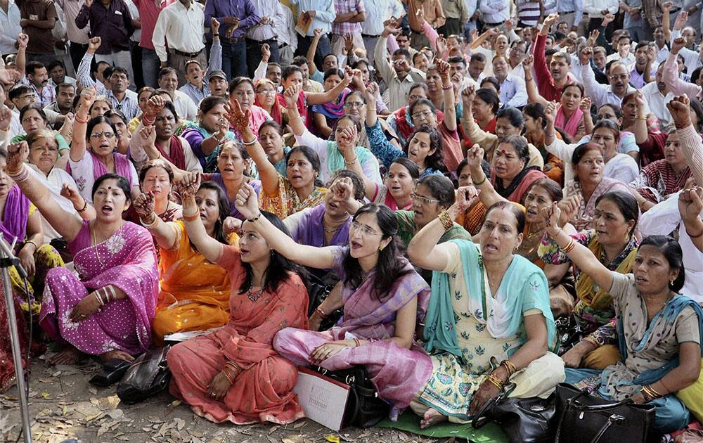 Women along with other Uttarakhand government employees observing a `Karva Chauth` protest in Dehradun on Tuesday demanding at least three promotions during their service tenure.