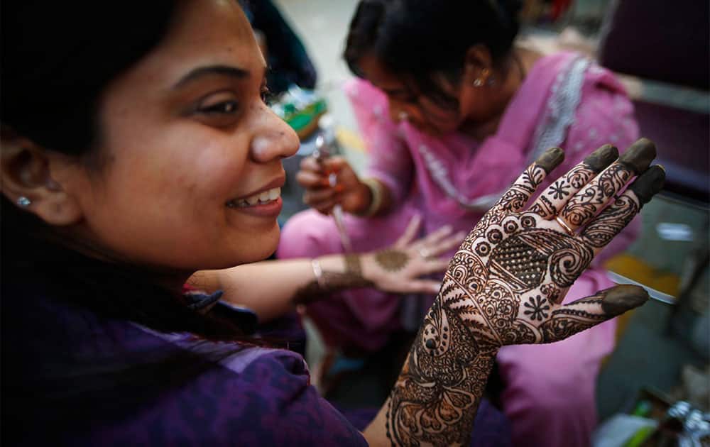 A Hindu woman gets her hand decorated with henna ahead of the Hindu festival of Karva Chauth in New Delhi.