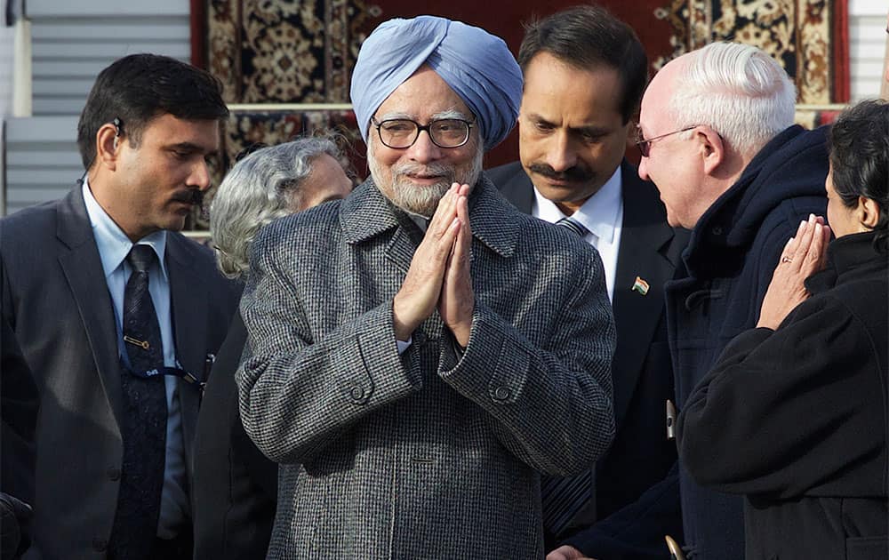 Prime Minister Manmohan Singh greets officials upon his arrival at the Government Airport Vnukovo-2 outside Moscow, Russia.