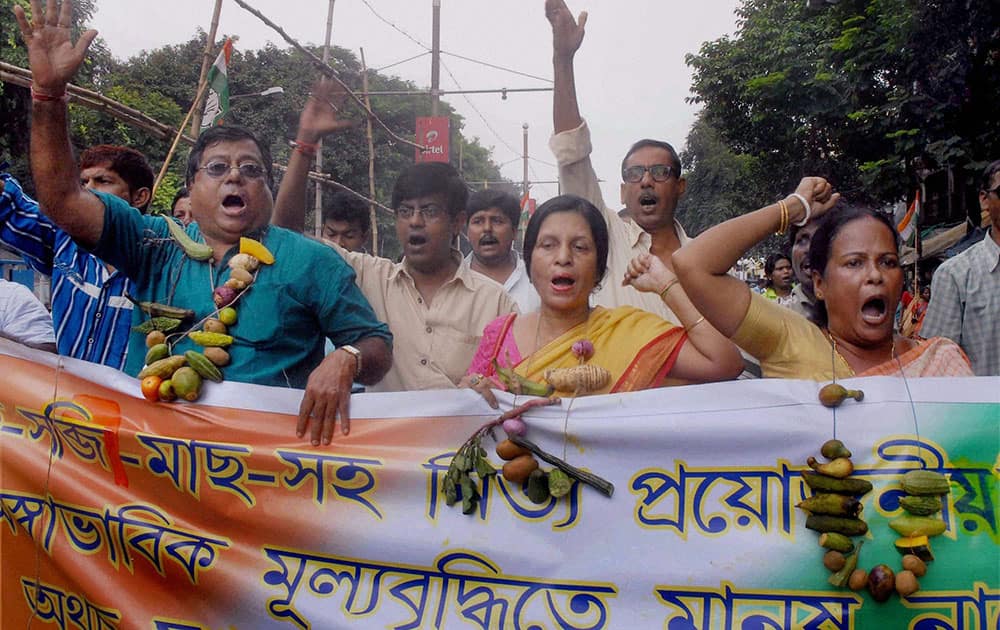 Congress activists take part in a rally to protest against State Government for price hike of essential commodities, in Kolkata.