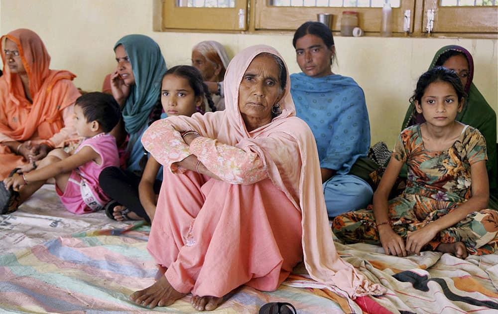 Vilagers of Suchetgarh border take shelter at a community hall over fear of becoming targets of shelling from Pakistan side at Kali Bari village in Samba 45km from Jammu.