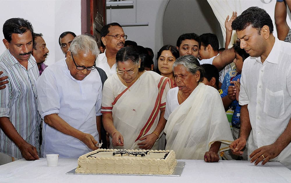 CPI(M) veteran and former Kerala CM V S Achuthanandan cuts cake on his 90th birth day with his wife Vasumathi and other family members in Thiruvananthapuram.