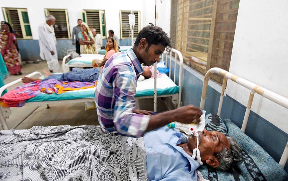 Maroof, 60, receives treatment after falling ill from consuming tainted liquor, at a hospital in Azamgarh, India, Saturday, Oct. 19, 2013. A batch of toxic bootleg liquor killed at least 32 people, mostly poor laborers, and sickened dozens more in northern India, police said.