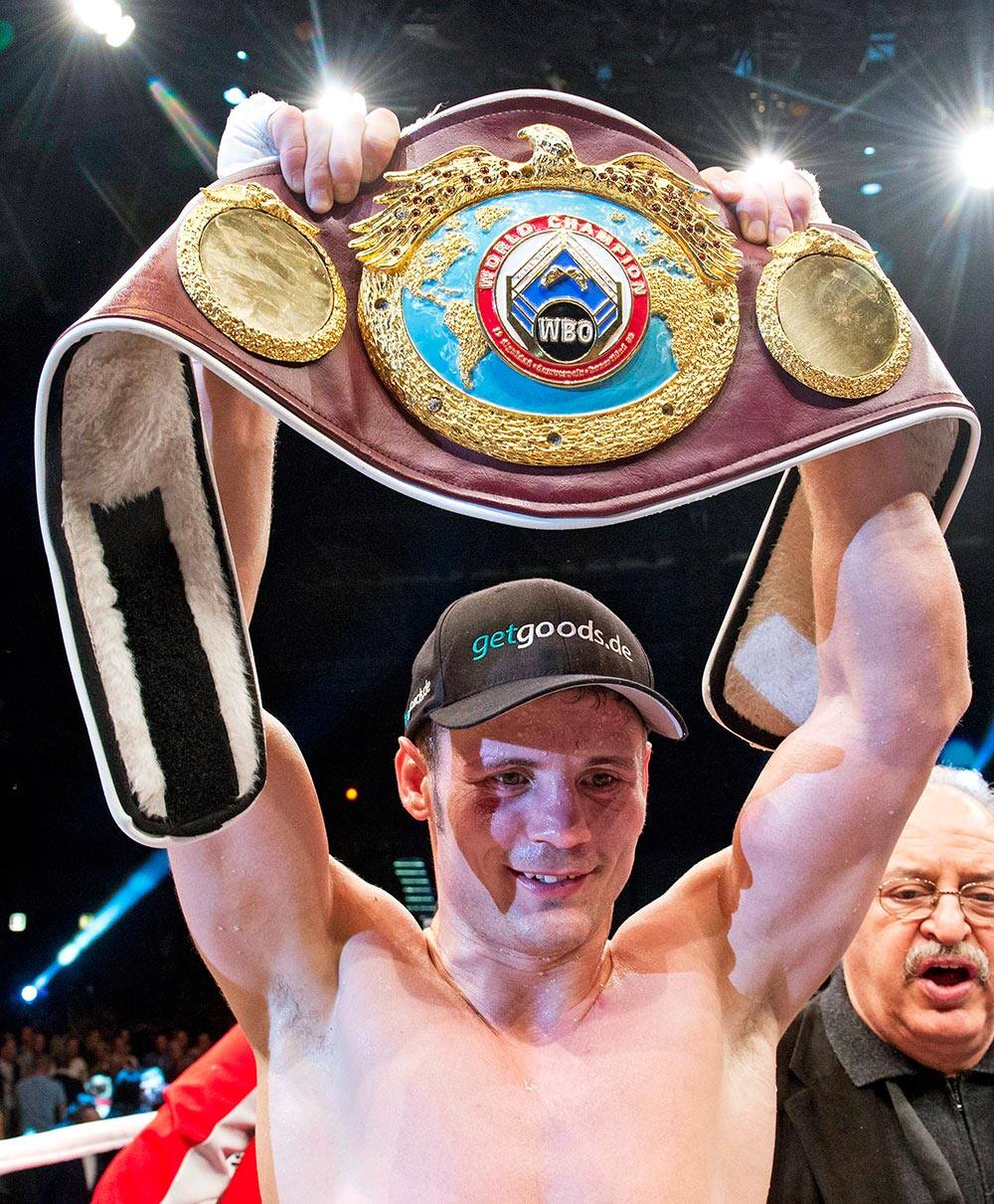 Robert Stieglitz of Germany holds up the title belt after winning his WBO Super Middleweight Championship bout against Isaac Ekpo of Nigeria in Leipzig, central Germany. Stieglitz retained his title.