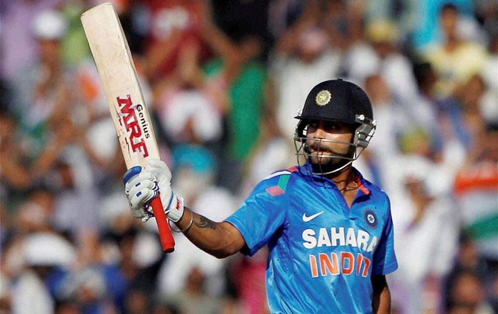 Indian batsman Virat Kohli celebrates his fifty against Australia during the 3rd ODI cricket match at PCA stadium in Mohali.