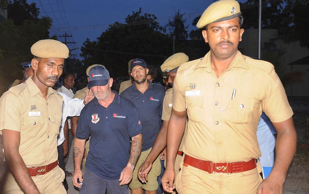 Policemen escort crew members of a US-owned ship MV Seaman Guard Ohio outside a court in Tuticorin, in the southern Indian state of Tamil Nadu.