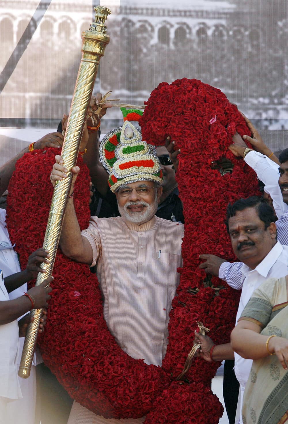 Gujarat state Chief Minister and Bharatiya Janata Party (BJP) leader Narendra Modi receives scepter and a floral garland during his visit to Chennai.