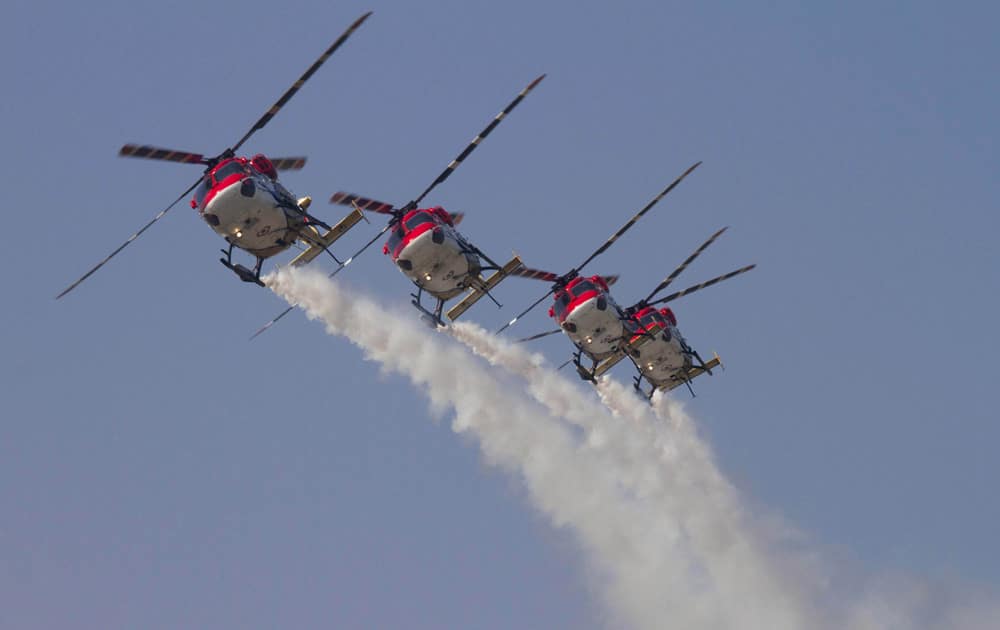 Indian Air Force (IAF) Sarang helicopters perform a display flight at Air Force Station on the outskirts of Srinagar.