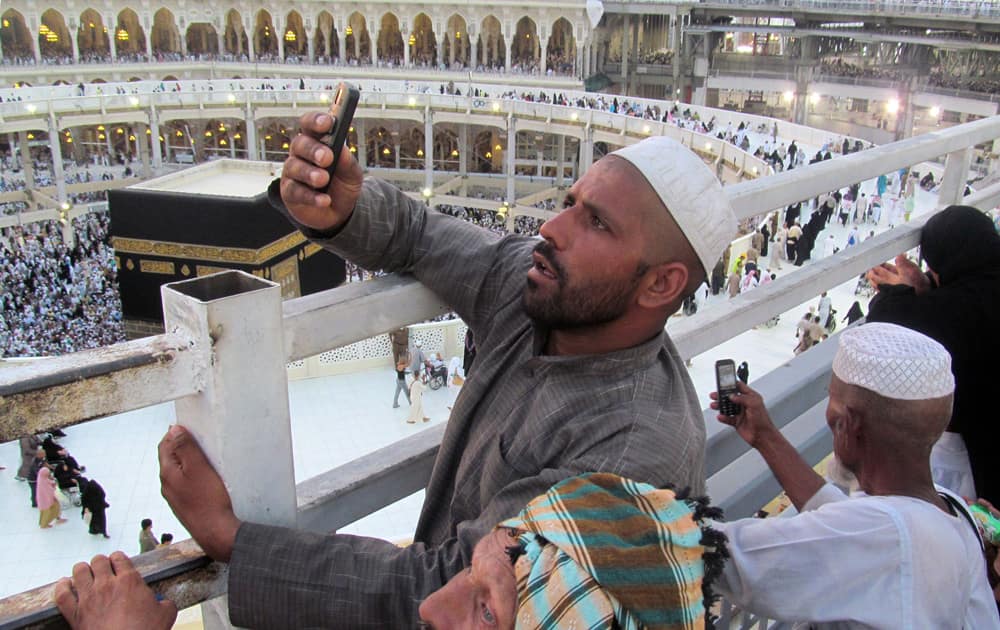 Muslim pilgrims take pictures of the Grand Mosque, in the Muslim holy city of Mecca, Saudi Arabia.