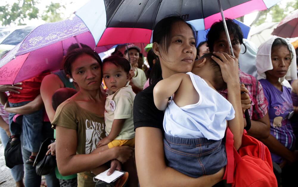 Residents queue up to receive cash handouts given by the government in quake-hit Sagbayan township, Bohol province in central Philippines.