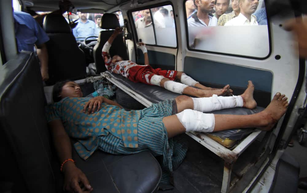 Indian village girls Asha and Rama, injured reportedly in firing and shelling from the Pakistan side of the India-Pakistan border, lie inside an ambulance outside a hospital in Jammu.