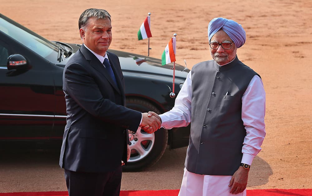Hungary`s Prime Minister Viktor Orban, is received by Indian Prime Minister Manmohan Singh as he arrives for a ceremonial reception at the Indian presidential palace in New Delhi.