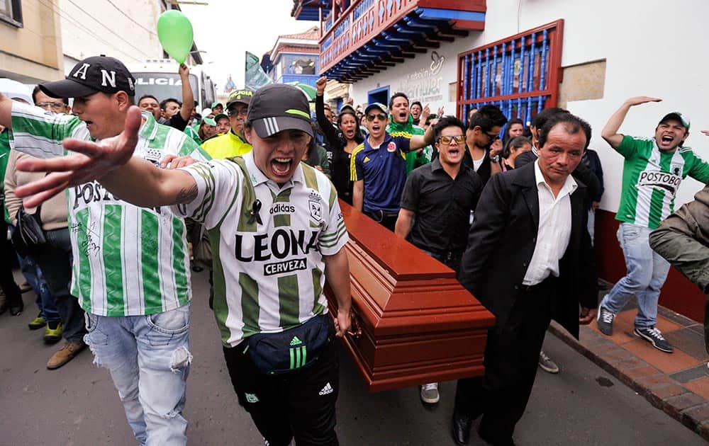 Friends and relatives carry the coffin that contain the remains of Atlético Nacional soccer fan, Dumar Baquero, in Zipaquira, Colombia.