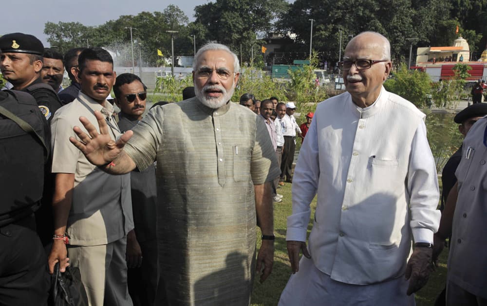 Gujarat state Chief Minister Narendra Modi walks with L.K. Advani during the inauguration of a riverfront park in Ahmadabad.