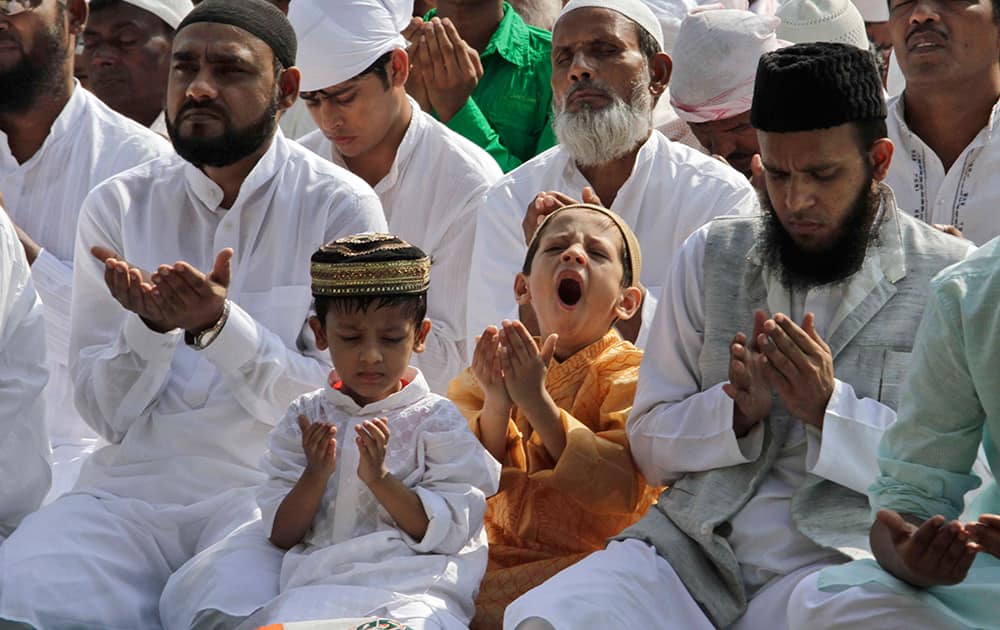A boy yawns as Muslims offer prayers during Eid al-Adha, or the Feast of the Sacrifice, in Kolkata.