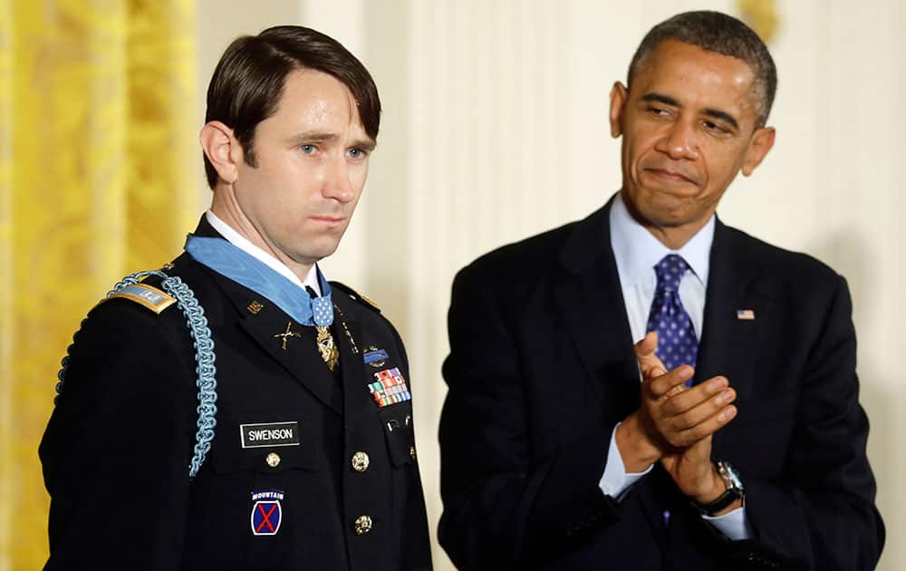 President Barack Obama, applauds after awarding the Medal of Honor to former Army Capt. William D. Swenson of Seattle, Wash., during a ceremony in the East Room at the White House in Washington.