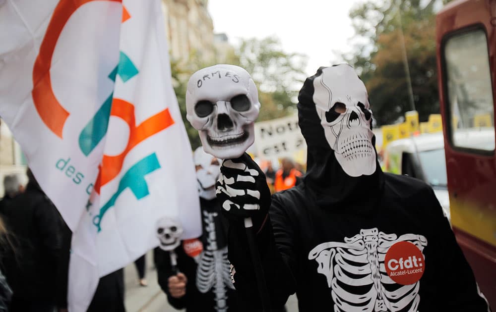Alcatel-Lucent workers dressed as skeletons demonstrate in front of the company headquarters in Paris.