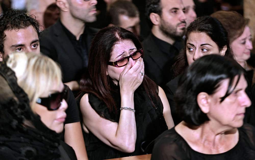 A Lebanese woman weeps during the funeral of leading Lebanese singer and composer Wadih Safi at the Saint Georges Cathedral, in down town Beirut, Lebanon.