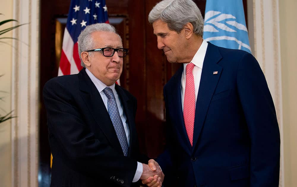 UN-Arab League envoy for Syria Lakhdar Brahimi, left, shakes hands with US Secretary of State John Kerry after their meeting at Winfield House, the residence of the US Ambassador to Britain, in London.