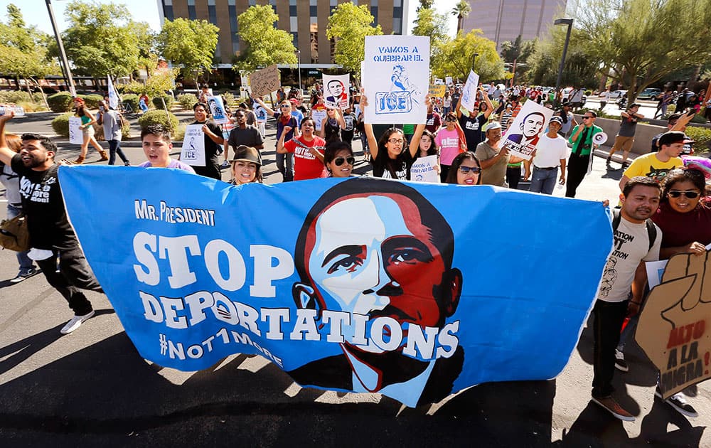 Upset with President Barack Obama`s immigration policy, about 250 people march to the U.S. Immigrations and Customs Enforcement office with a goal of stopping future deportations, in Phoenix.