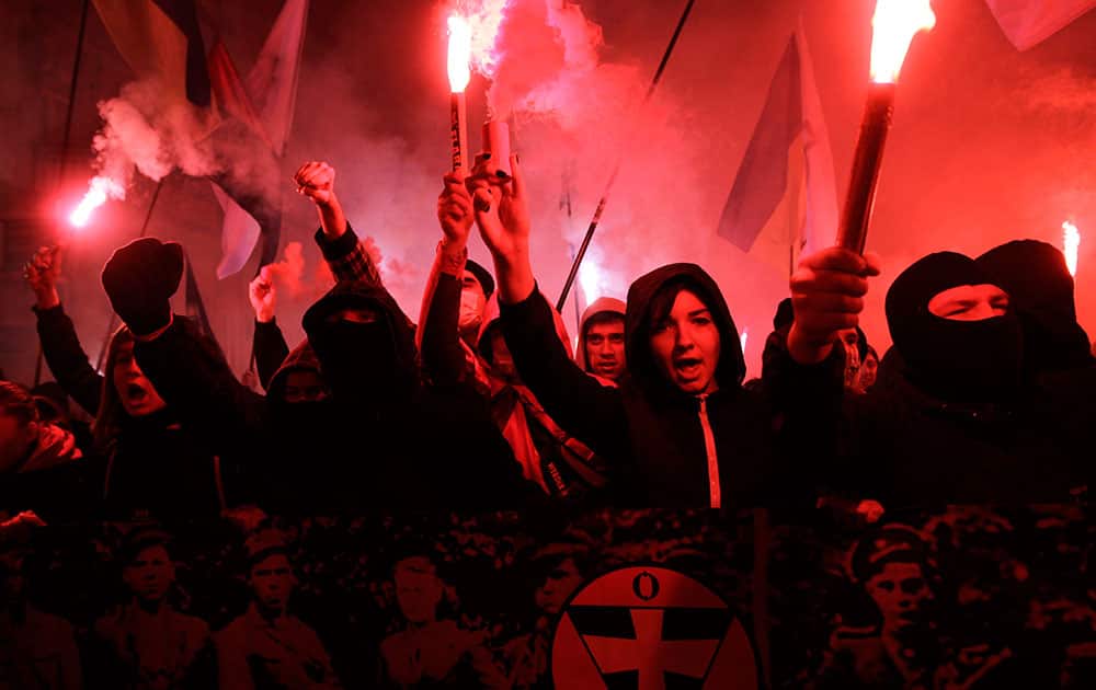 Ukrainian nationalists hold flares and shout out slogans during a rally to mark the 71st anniversary of the Ukrainian Insurgent Army in Kiev, Ukraine.
