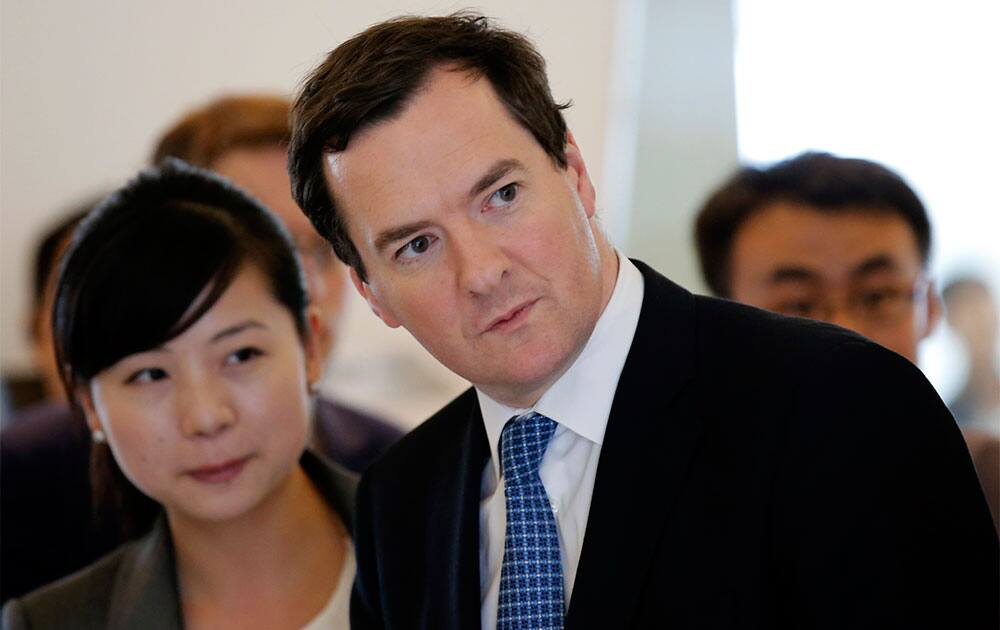 Britain’s Chancellor of the Exchequer George Osborne looks around interior of a building during his tour of Galaxy SOHO, a newly built urban complex building, in Beijing, China.