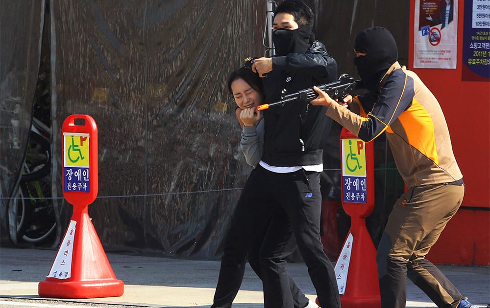 Mock terrorists threaten a hostage during an anti-terrorism exercise at a shopping center in Seoul, South Korea.