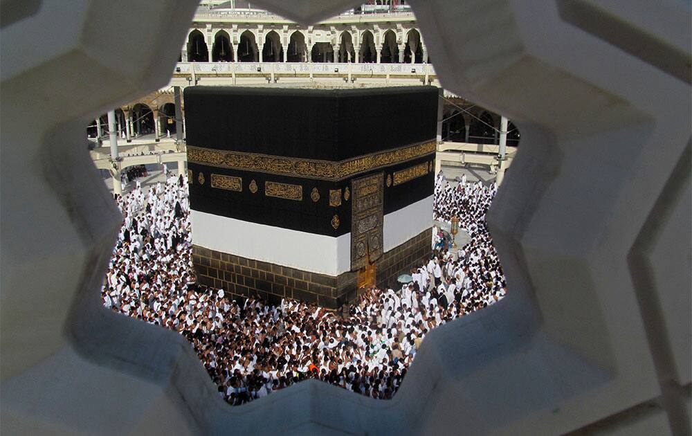 Muslim pilgrims are seen through a decorative window of the Grand Mosque as they circle around the Kaaba, the cube-shaped structure in the city’s Grand Mosque that Muslims around the world face in prayer five times a day, in the Muslim holy city of Mecca.