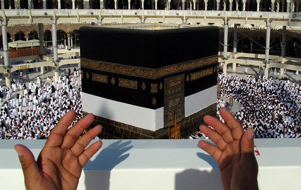 A Muslim pilgrim prays in front of the Kaaba, the cube-shaped structure in the city’s Grand Mosque that Muslims around the world face in prayer five times a day, in the Muslim holy city of Mecca, Saudi Arabia.