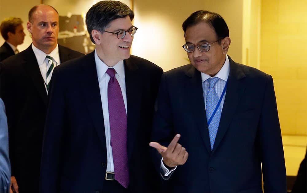 US Secretary of the Treasury Jacob Lew, second from left, and Shri P. Chidambaram, the Finance Minister for India, leave after their bi-lateral meeting at the International Monetary Fund, in Washington.