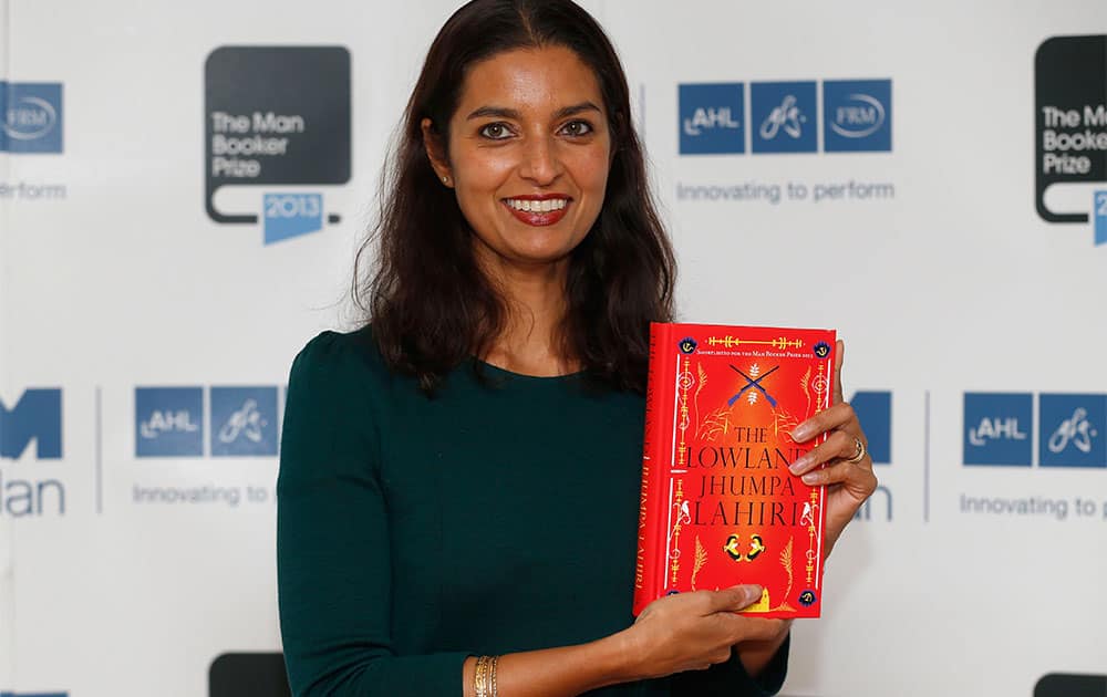 United States author Jhumpa Lahiri poses with her book `The Lowland` during a photocall for the shortlisted authors of the 2013 Man Booker Prize for Fiction at the Queen Elizabeth Hall in London.