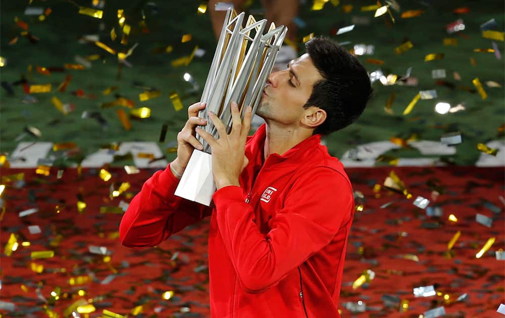 Serbia`s Novak Djokovic kisses his trophy during the award ceremony of the Shanghai Masters tennis tournament at Qizhong Forest Sports City Tennis Center.