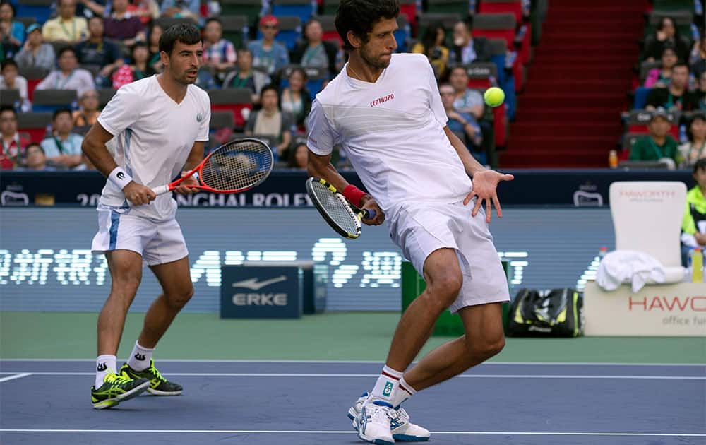 Brazil`s Marcelo Melo, right, and Croatia`s Ivan Dodig play against Spain`s David Marrero and compatriot Fernando Verdasco in the doubles final match of the Shanghai Masters tennis tournament at the Qizhong Forest Sports City Tennis Center in Shanghai, China.