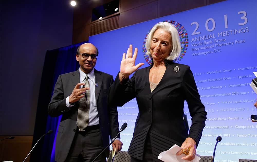 International Monetary Fund (IMF) Managing Director Christine Lagarde, right, waves as she departs with Singaporean Minister for Finance Tharman Shanmugaratnam, who is also the chairman of the IMFC, after a media availability, during the World Bank/IMF Annual Meetings at IMF headquarters.