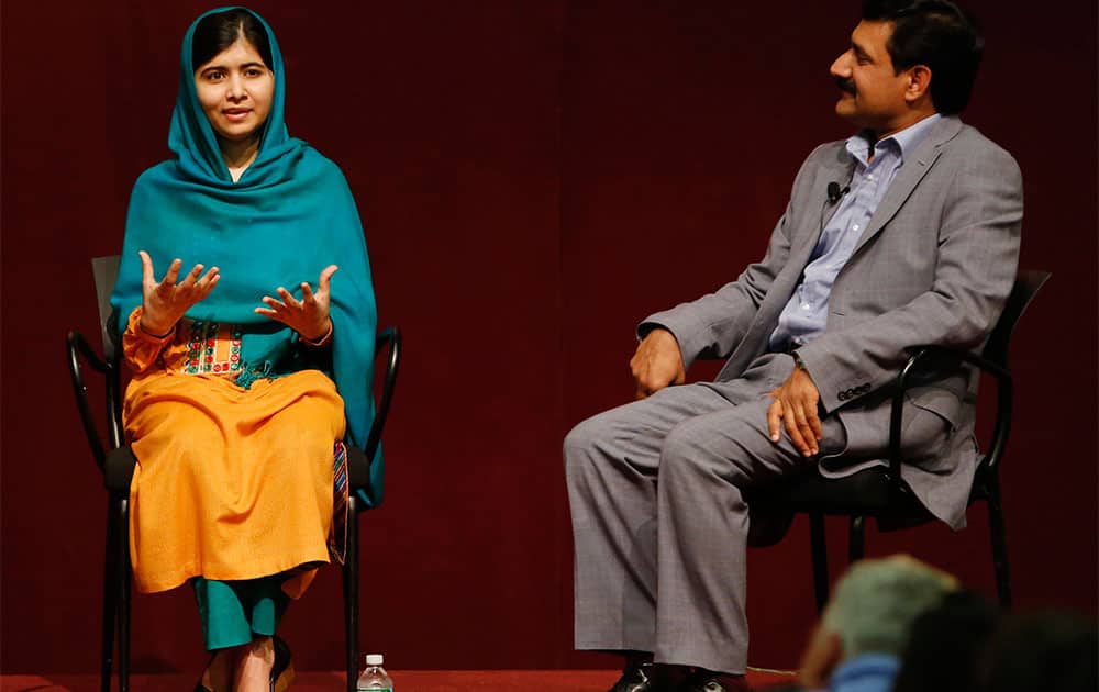 Malala Yousafzai gestures as she speaks to an audience during a discussion of her book,