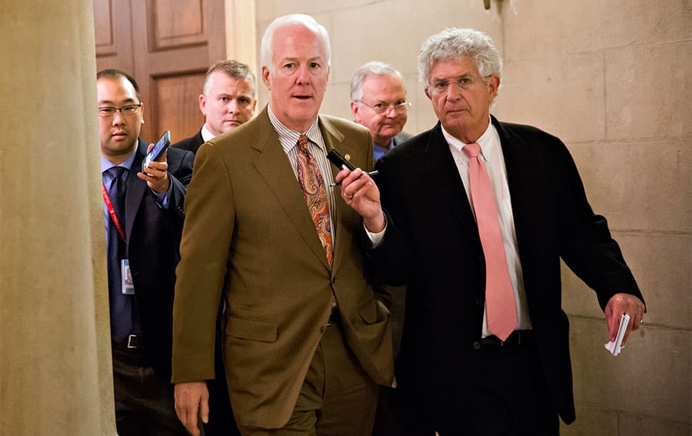 Senate Minority Whip John Cornyn of Texas, is pursued by reporters as he and other Republican senators returned to Capitol Hill in Washington, after a two-hour meeting at the White House with President Barack Obama, trying to come up with a bipartisan solution to the budget stalemate.